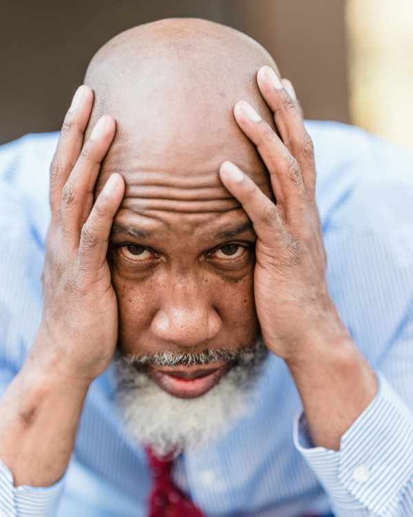 Wellbeing Solutions with MATL Bearded businessman holding his head in his hand with anxiety. Limely to benefit from Havening with MATL under the Wellbeing and Mentoring Service
